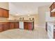 Spacious kitchen with dark wood cabinetry, white appliances, and tile flooring, great layout at 514 Richmond Ave, Deltona, FL 32725