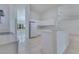 Bright kitchen featuring white cabinets, tile floor, and stainless steel appliances at 514 Richmond Ave, Deltona, FL 32725