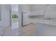 Bright kitchen featuring white cabinets, tile floor, and stainless steel appliances at 514 Richmond Ave, Deltona, FL 32725