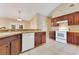 Well-lit kitchen with wood cabinets, white appliances, and tile backsplash, perfect for cooking at 514 Richmond Ave, Deltona, FL 32725