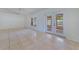 Open living area boasts tile flooring, bright light, and double doors leading to outdoor patio at 514 Richmond Ave, Deltona, FL 32725