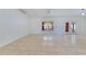 Well-lit living room with tile flooring, neutral walls, and large windows at 514 Richmond Ave, Deltona, FL 32725