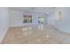 Well-lit living room with tile flooring, neutral walls, and large windows at 514 Richmond Ave, Deltona, FL 32725