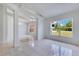 Open-concept living area with tile floors, bright lighting and large windows at 514 Richmond Ave, Deltona, FL 32725