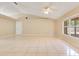 Bright living area with tile floors, neutral walls, ceiling fan, and a large window at 514 Richmond Ave, Deltona, FL 32725
