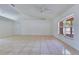 Bright living room with tile floors, a ceiling fan, and large windows allowing ample natural light at 514 Richmond Ave, Deltona, FL 32725