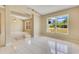 Open living room featuring large windows, neutral walls, and tile floors, connecting living spaces at 514 Richmond Ave, Deltona, FL 32725