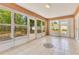 Bright sunroom featuring tile floors, surrounded by windows with backyard views at 514 Richmond Ave, Deltona, FL 32725