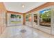 Bright sunroom featuring tile floors, surrounded by windows with backyard views at 514 Richmond Ave, Deltona, FL 32725