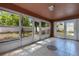 Enclosed sunroom with tile flooring, numerous windows, and backyard views at 514 Richmond Ave, Deltona, FL 32725