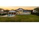 Stunning backyard of this house features a luxurious pool, outdoor entertaining space, and picturesque sunset views at 6139 Greatwater Dr, Windermere, FL 34786