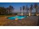 Beautiful lakefront estate with lush landscape, private dock, and peaceful lake views during sunset at 6139 Greatwater Dr, Windermere, FL 34786