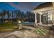 Beautiful backyard with manicured lawn, patio, and inviting outdoor living spaces steps from the water at 6139 Greatwater Dr, Windermere, FL 34786