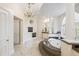 Elegant bathroom featuring a soaking tub, chandelier, and ample natural light at 6139 Greatwater Dr, Windermere, FL 34786