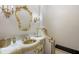 Elegant bathroom featuring marble countertop, gold fixtures and decorative tile accent at 6139 Greatwater Dr, Windermere, FL 34786