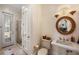 Bright bathroom features a standalone vanity, framed mirror, and walk-in shower with natural lighting at 6139 Greatwater Dr, Windermere, FL 34786