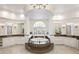 Luxurious bathroom featuring jacuzzi tub on platform and dual vanities at 6139 Greatwater Dr, Windermere, FL 34786