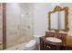 Luxurious bathroom showcases glass shower, mosaic tile accents, and ornate mirror above the vanity at 6139 Greatwater Dr, Windermere, FL 34786