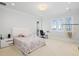 Spacious bedroom with a hammock, desk, and water view at 6139 Greatwater Dr, Windermere, FL 34786