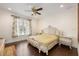 Elegant bedroom features hardwood floors, ceiling fan, and natural light from the window at 6139 Greatwater Dr, Windermere, FL 34786