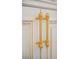Close-up of a white cabinet doors with gold hardware adorned with crystals at 6139 Greatwater Dr, Windermere, FL 34786