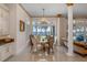 Bright dining area with water views, chandelier, and open layout to the kitchen at 6139 Greatwater Dr, Windermere, FL 34786