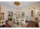 Elegant dining room with a crystal chandelier, decorative ceiling, and ornate furnishings at 6139 Greatwater Dr, Windermere, FL 34786