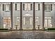 Grand entrance with stately columns, intricate detailing, and elegant landscaping provides a welcoming first impression at 6139 Greatwater Dr, Windermere, FL 34786