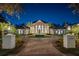 Elegant estate features a circular driveway, lush landscaping, and a grand entrance with stately columns at 6139 Greatwater Dr, Windermere, FL 34786