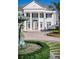 A home's exterior has a fountain, statues, columns, and meticulous landscaping at 6139 Greatwater Dr, Windermere, FL 34786