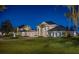 Elegant estate with lush landscaping, a circular driveway, and stately columns showcases luxury living at 6139 Greatwater Dr, Windermere, FL 34786