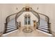 Grand foyer with dual curved staircases, marble floors, and elegant chandelier at 6139 Greatwater Dr, Windermere, FL 34786