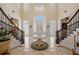 Expansive foyer featuring a grand staircase, pristine marble flooring, and an ornate chandelier at 6139 Greatwater Dr, Windermere, FL 34786