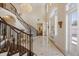 Impressive foyer boasts a winding staircase, marble floors, and abundant natural light at 6139 Greatwater Dr, Windermere, FL 34786