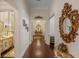 Hallway with hardwood floors, ornate mirror and views into rooms with elegant decor at 6139 Greatwater Dr, Windermere, FL 34786