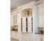 Custom kitchen cabinetry with gold hardware and pull-out shelving offers ample storage space at 6139 Greatwater Dr, Windermere, FL 34786