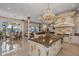 Gourmet kitchen with large island, lake view, chandeliers, and stainless steel appliances at 6139 Greatwater Dr, Windermere, FL 34786