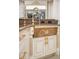The kitchen features a custom sink with a waterfall view and gold accents on the cabinetry at 6139 Greatwater Dr, Windermere, FL 34786