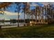 Scenic lakeside with mature trees, a charming dock with gazebo, and a well-maintained lawn at 6139 Greatwater Dr, Windermere, FL 34786