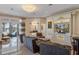 Gorgeous living room with lake view features a chandelier, custom built-ins, and marble tile floors at 6139 Greatwater Dr, Windermere, FL 34786