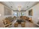 Luxurious living room with water view, chandelier, and ornate gold trim at 6139 Greatwater Dr, Windermere, FL 34786