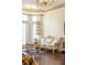 Living room with elegant furniture, hardwood floors, and light from large windows at 6139 Greatwater Dr, Windermere, FL 34786