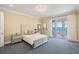 Bedroom with water views, a balcony, and stylish furnishings at 6139 Greatwater Dr, Windermere, FL 34786