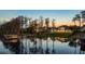 Tranquil pool area features elegant statues, lush landscaping, and serene water views, perfect for relaxation at 6139 Greatwater Dr, Windermere, FL 34786