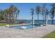 Wide shot of the backyard featuring an amazing pool, lake, statues, and trees at 6139 Greatwater Dr, Windermere, FL 34786