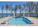 Inviting in-ground pool with a waterfall feature and scenic lake views at 6139 Greatwater Dr, Windermere, FL 34786