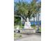 Statue in the backyard offering an artistic touch with a serene lake backdrop at 6139 Greatwater Dr, Windermere, FL 34786
