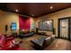 Home theater with tiered seating, projector screen, and plush seating at 6139 Greatwater Dr, Windermere, FL 34786