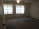 Spacious bedroom featuring neutral carpet, ceiling fan, and natural light at 672 Post Oak Cir # 106, Altamonte Springs, FL 32701