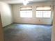 Spacious bedroom with plush carpeting and ample natural light from two large windows at 672 Post Oak Cir # 106, Altamonte Springs, FL 32701